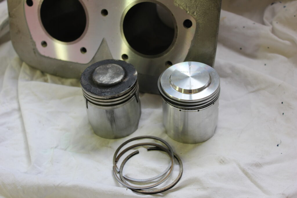 Old and new piston and piston rings.  Ariel Square Four